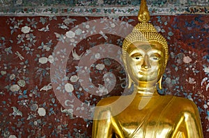 Golden buddha over grunge wall