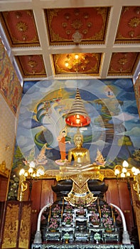 Golden Buddha in painted chapel