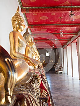 Golden Buddha sculpture in lotus position sitting