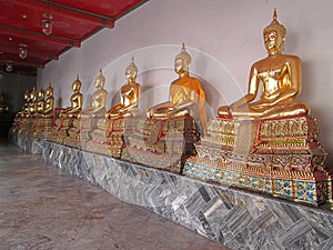 A golden Buddha sitting in the corridor of Wat Pho