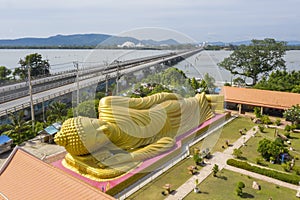 Golden Buddha statue against blue sky in South of Thailand temple