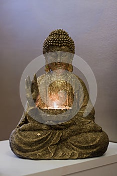 Golden Buddha statue and a candle