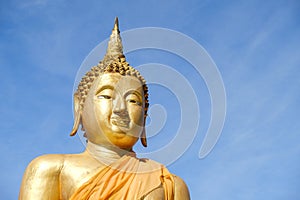 Golden Buddha statue on a clear sky background