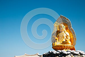 Golden buddha statue at Haedong Yonggungsa Temple in Busan, Korea