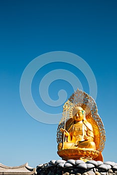 Golden buddha statue at Haedong Yonggungsa Temple in Busan, Korea