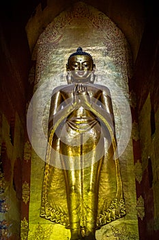Golden Buddha statue inside the Ananda temple in Bagan