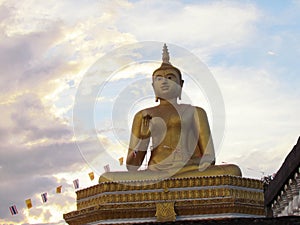 Golden buddha statue with a spectacular of clouds and sky backgr