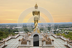 Golden Buddha statue standing at Wat Phra That Khao Noi, Nan Province, Thailand