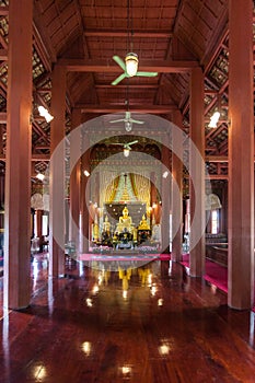 Golden buddha statue in wooden temple