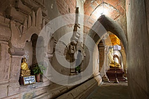 Golden Buddha statues inside a temple in Bagan