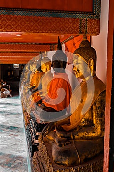 Golden Buddha statues with orange bands Surat Thani Thailand