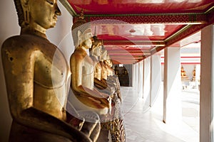 Golden Buddha statues in a row