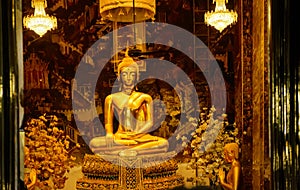 Golden Buddha statues in a Thai Buddhist temple.