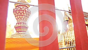 Golden Buddhist bell for prayer wishes in sunlight at Wat Phra T