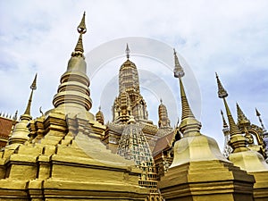 Golden buddhist temple with stupa, replica of an ancient thai temple in Ancient City at Muang Boran in Thailand