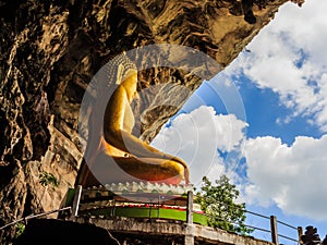 Golden buddhist in wild cave