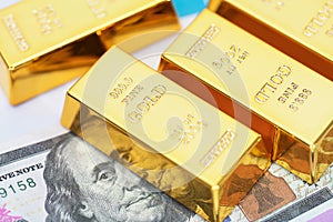Golden bullion on dollar bills