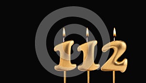 Golden candle 112 with flame - Birthday card on dark luxury background