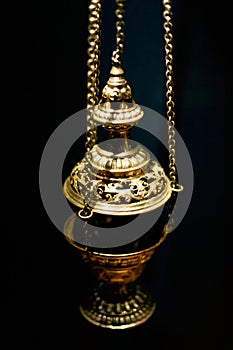 Golden candlestick on a black background