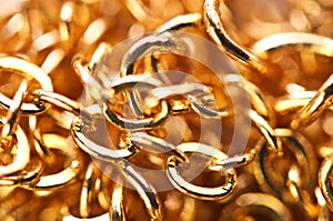 Golden chain links close-up full screen.