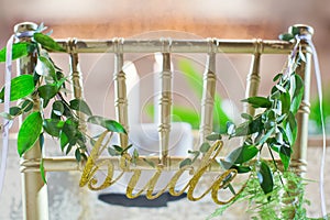 Golden chairs bride groom with green