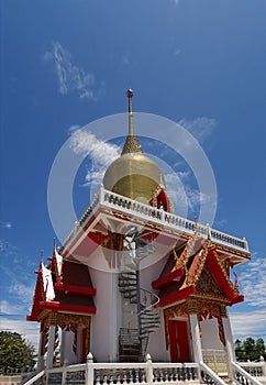Golden chedi soars into blue sky
