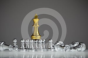 Golden chess king stood out on the silver pawn. King wins the game, success, strategy, victory, win checkmate, Concept leadership