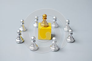 Golden chess pawn pieces or leader  businessman with circle of silver men. victory, leadership, business success, team, and