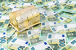 Golden chest on many 100 euro banknotes as background, Pandora chest concept of financial hazards