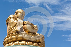 Golden Chinese buddha on blue sky background