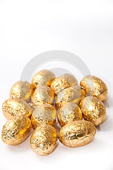 Golden chocolate easter egg on the white background