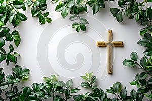 Golden christian cross with green leaves on white background. Happy Easter holiday