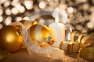 Golden Christmas background with candles, baubles and ribbons