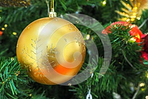 Golden christmas ball hanging on Christmas tree