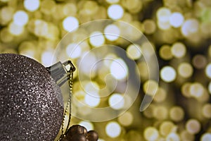 golden christmas ball on a light background, New Year's decorations, macro photography. Merry Christmas and Happy New Year.