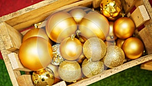 Golden Christmas ball in a wooden crate