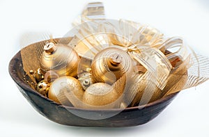 Golden Christmas baubles in a bowl