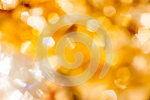 Golden Christmas Bokeh Background. Gold Holiday glowing Abstract Glitter Defocused