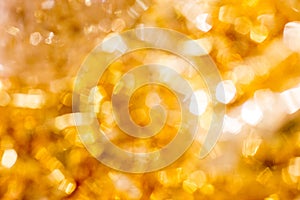 Golden Christmas Bokeh Background. Gold Holiday glowing Abstract Glitter Defocused Background