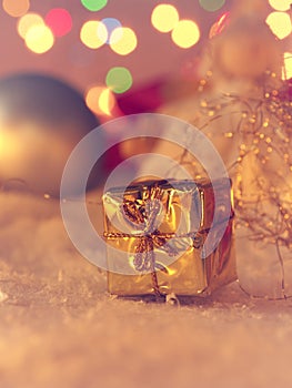 Golden Christmas gift box in snow vintage color stylized