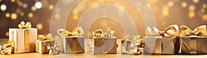 Golden Christmas gifts, balls and decorations in a row on a gold abstract background.