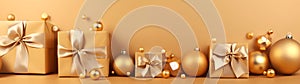 Golden Christmas gifts, balls and decorations in a row on a gold abstract background.