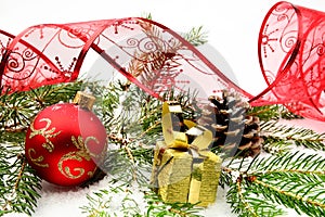 Golden christmas gifts,baubles with red ribbon and needles fir o
