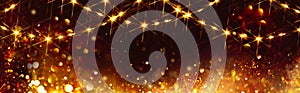 Golden Christmas and New Year glittering stars swirl on black bokeh background, backdrop with sparkling golden stars, garland