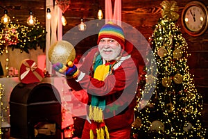 Golden christmas. new year at home. winter holiday weekend. man decorative ball. happy santa with beard. mature bearded