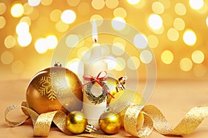 Golden Christmas ornament and candle