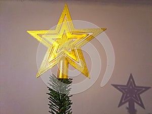 Golden Christmas Star isolated on white Background. Top View Close-Up Gold Star