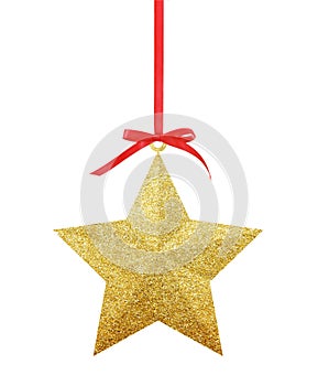 Golden Christmas star on red ribbon isolated on white