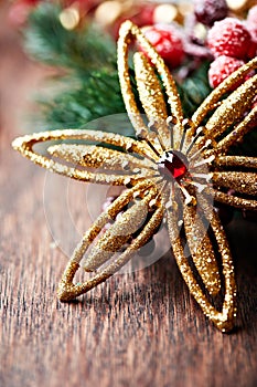 Golden christmas star on wooden background