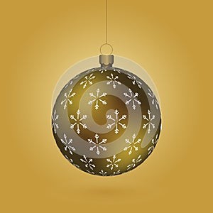 Golden Christmas ball with snowflakes print hanging on a golden chain photo
